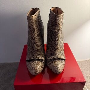 Nina Ricci bow accent snake skin, high heel booties.